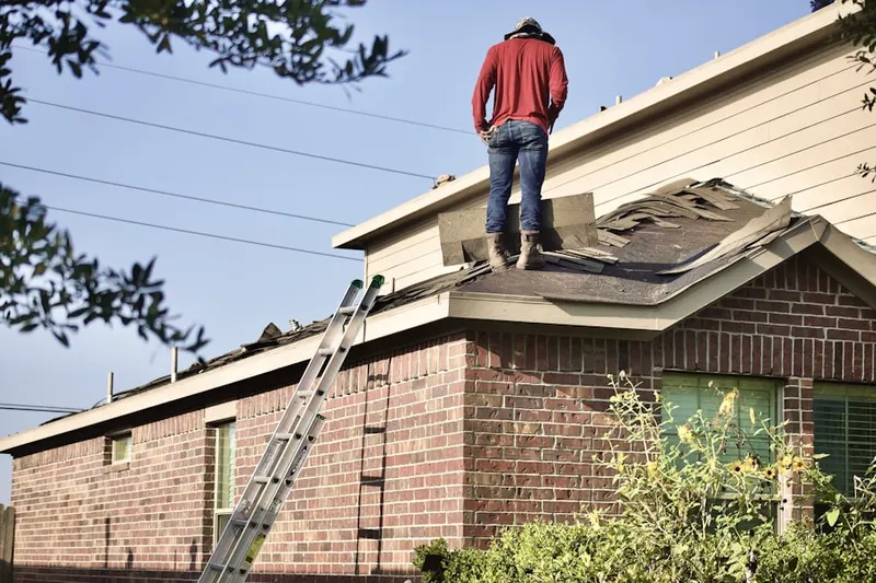 Professional roofer working on a residential roof in Polkville